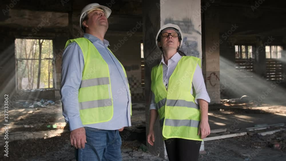customer and contractor shake hands as sign of successful deal to reconstruct dilapidated building. customer and contractor shake hands as sign of successful deal to reconstruct dilapidated building.