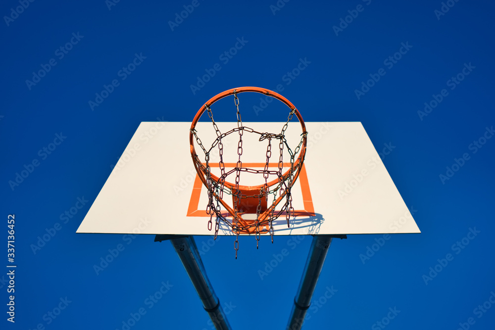 basketball hoop and net against blue sky on sunny day