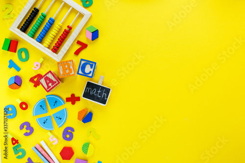 Fotografie, Obraz Colorful math fractions, numbers, letters on yellow background