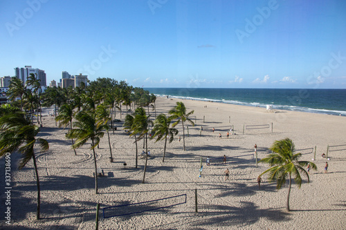 Fototapeta Naklejka Na Ścianę i Meble -  Balcony view of Ft. Lauderdale Beach volleyball and Palm trees