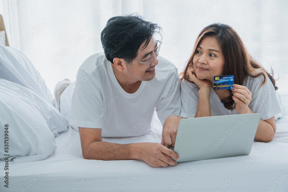 senior husband and wife are using laptop and credit card to buy products online. senior husband and wife are using laptop and credit card to buy products online.