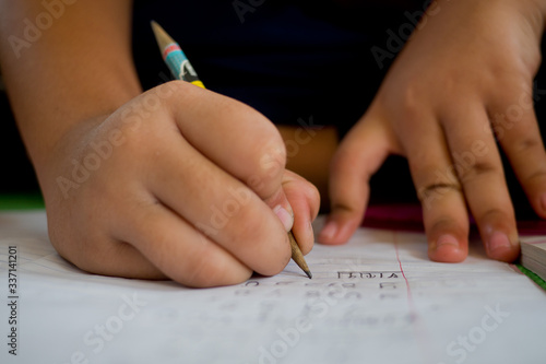 closeup hand writing paper, education concept 