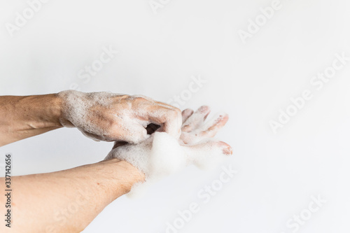 a man hands between fingers wash his hands with soap bubble cleaning hands wash off germs virus plain white background