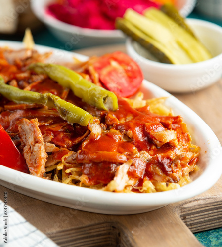 close up of turkish chicken doner kebab with shoestrings and tomato sauce