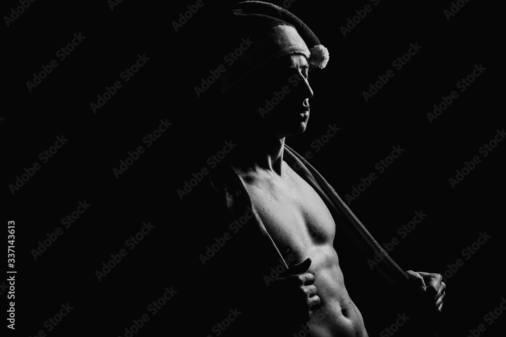 The pumped up body of a man. Black and white background. Sport. Clothing. Body. Beauty and fashion.