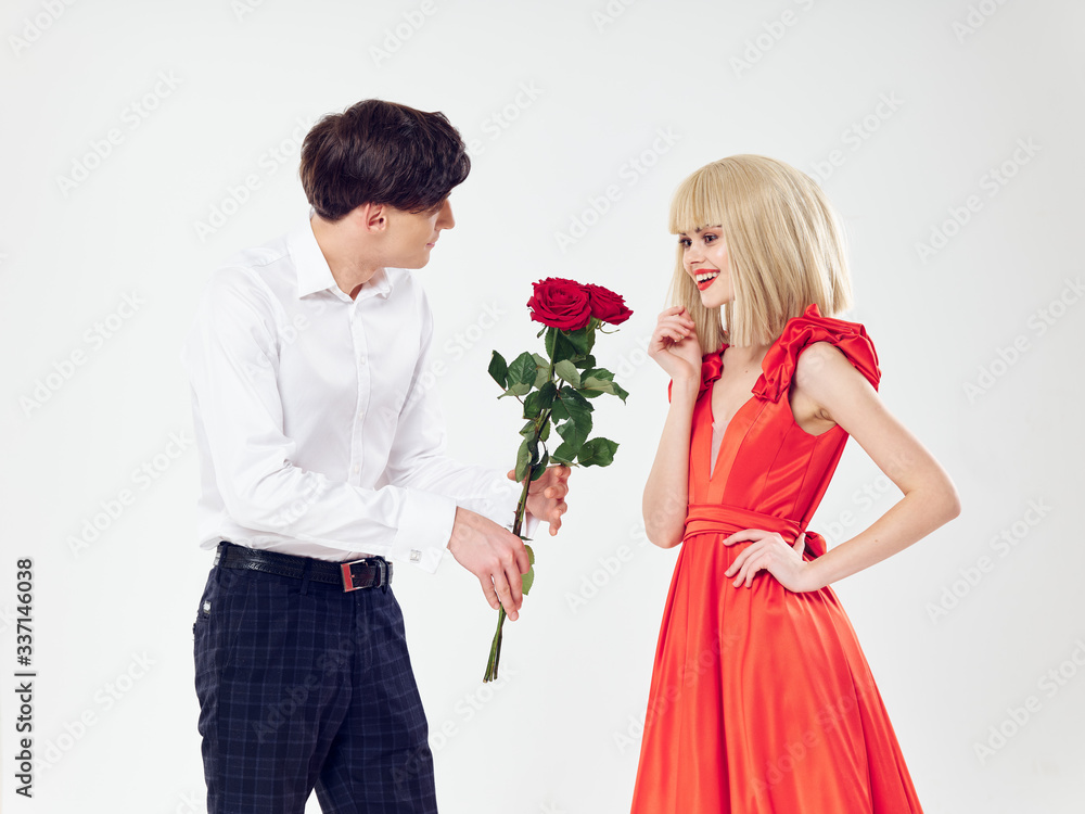 young couple holding a rose young couple holding a rose