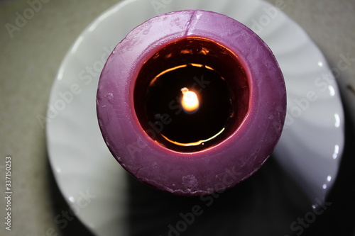 burning candle in a dish
