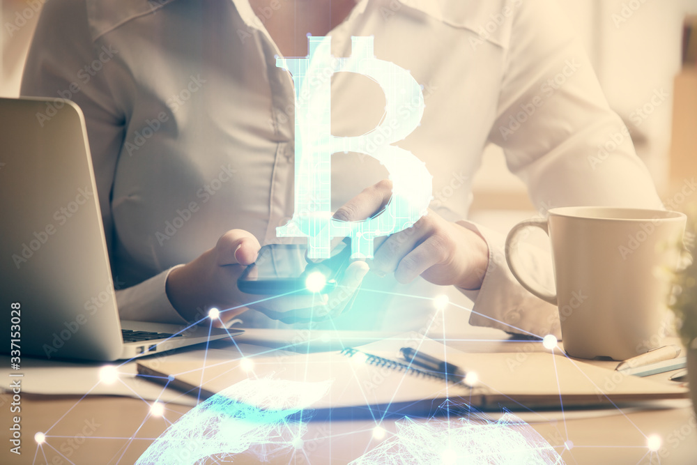 Double exposure of blockchain business sketch hologram and woman holding and using a mobile device. Double exposure of blockchain business sketch hologram and woman holding and using a mobile device.