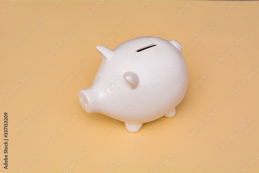 White pig piggy bank on a beige background. White pig piggy bank on a beige background.