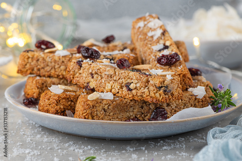 Granola bar. Healthy snack. Cereal granola bar with nuts, fruit, coconut and cranberries on a christmas table