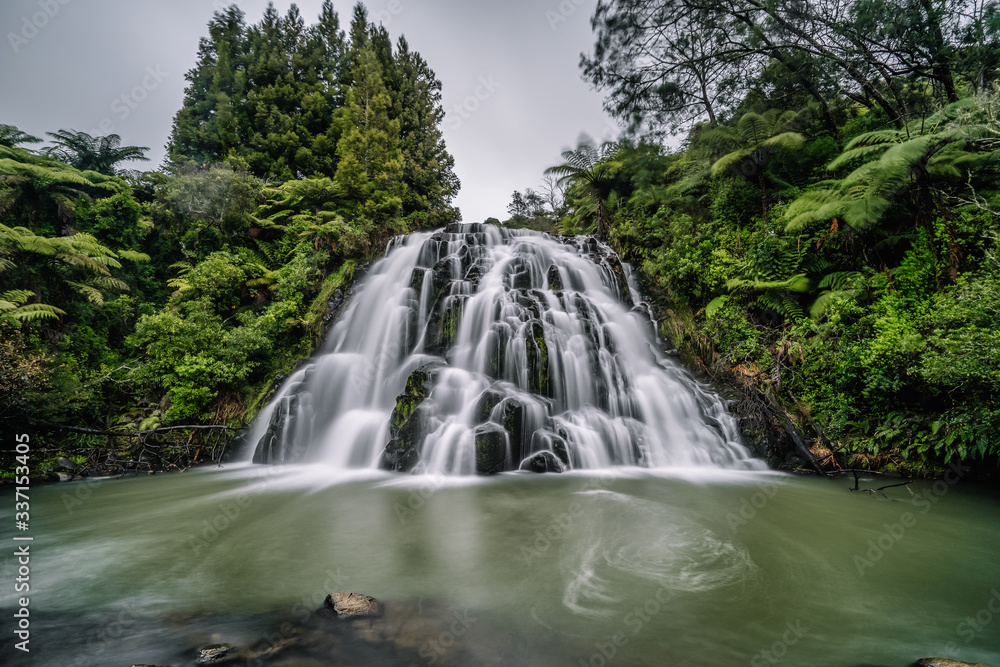 Sight of a waterfall during a hike in a local park Sight of a waterfall during a hike in a local park