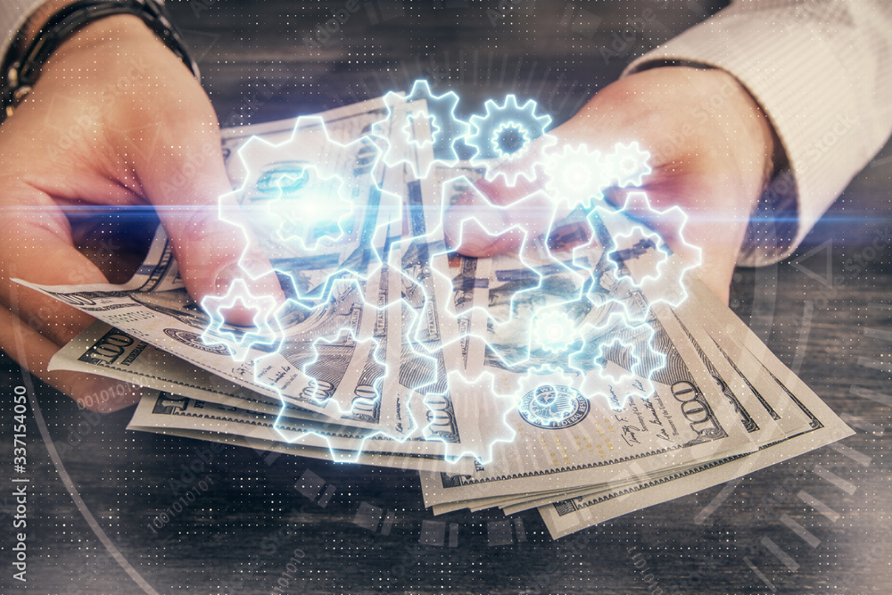 Multi exposure of financial theme drawing hologram and USA dollars bills and man hands. Business concept. Multi exposure of financial theme drawing hologram and USA dollars bills and man hands. Business concept.