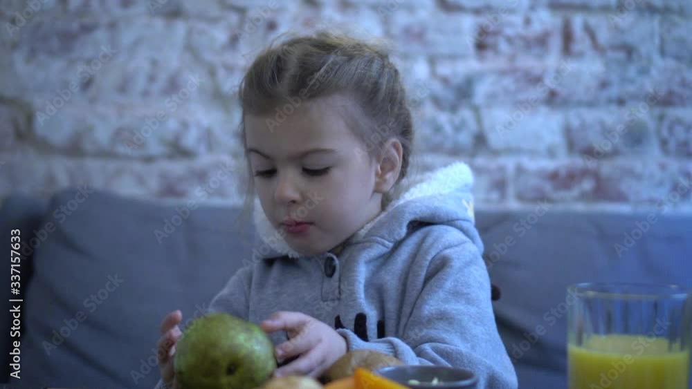 Child eating fruits. Healthy food and nutrition. Choosy kid not wanting to eat. Child eating fruits. Healthy food and nutrition. Choosy kid not wanting to eat.