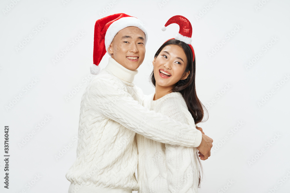 happy couple in christmas hats happy couple in christmas hats