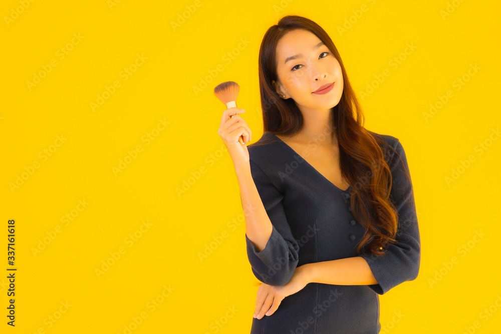 Portrait beautiful young asian woman with makeup brush Portrait beautiful young asian woman with makeup brush