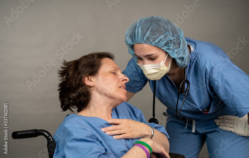 Nurse comforts an exhausted coleage photo