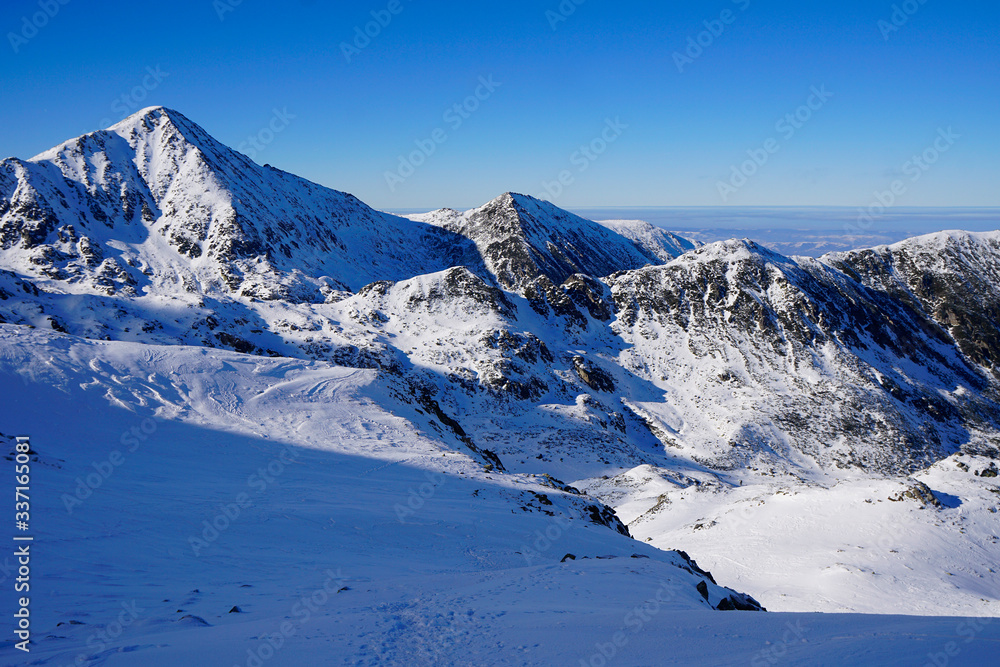 Scenic View Of Snowcapped Mountains Against Clear Blue Sky
