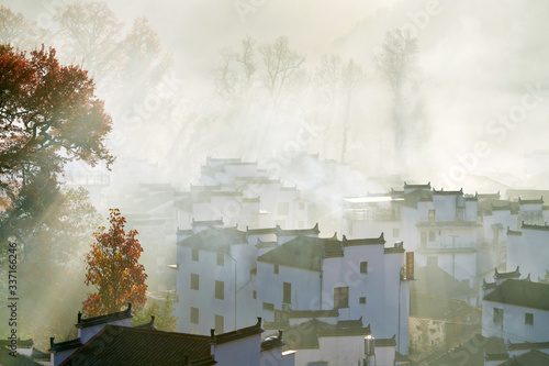 The morning fog on the dwellings of Anhui buildings in Wuyuan county Jiangxi province, China. photo