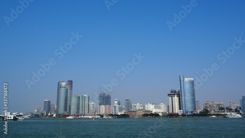 Sea By Cityscape Against Clear Sky #337166473