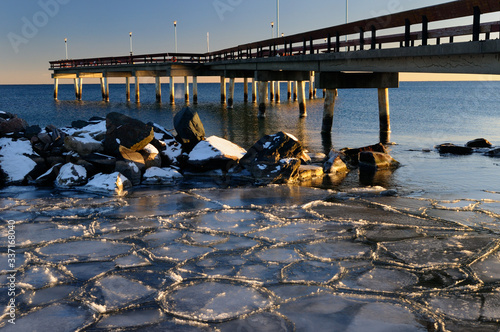 Photography Lake Ontario sunset at Toronto Center Island Pier in winter with ice flow tiles