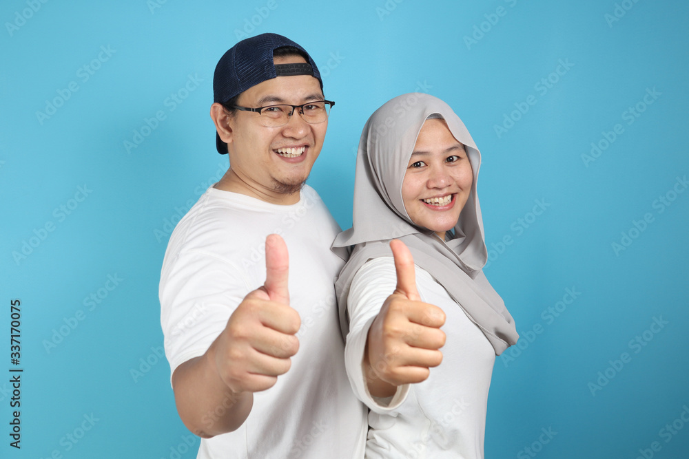 Happy Asian Muslim Couple Shows Thumbs Up Happy Asian Muslim Couple Shows Thumbs Up