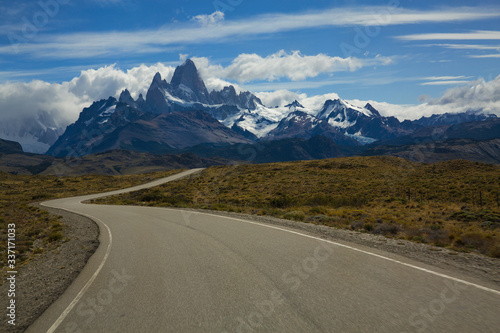 A windy road leads to Mt. Fitz Roy, surrounding mountains and the town of El Chalten, Argentina