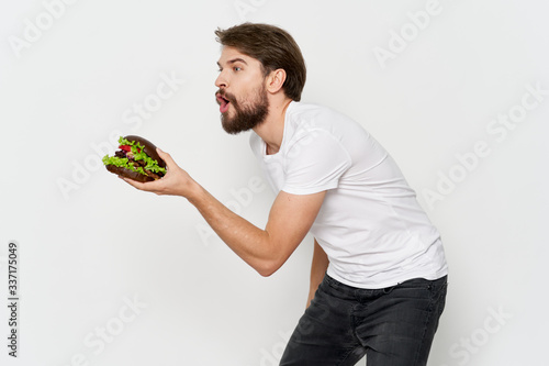 young man holding a bowl of fruit