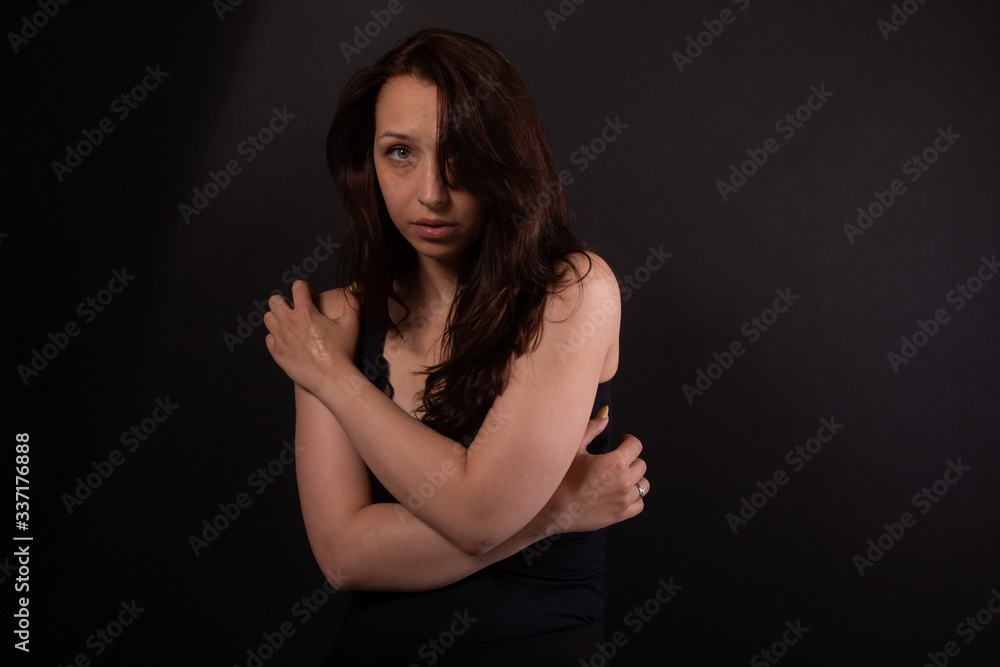 Caucasian girl in shy pose looks from under forehead. Harassment, me too concept Caucasian girl in shy pose looks from under forehead. Harassment, me too concept