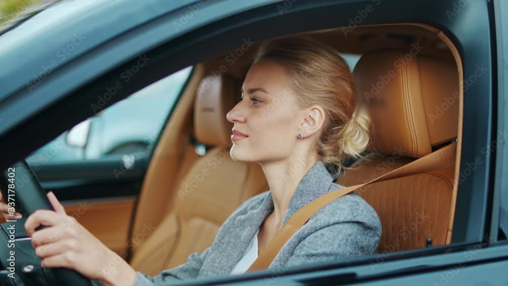 Closeup business woman dancing at automobile. Businesswoman sitting in new car Closeup business woman dancing at automobile. Businesswoman sitting in new car