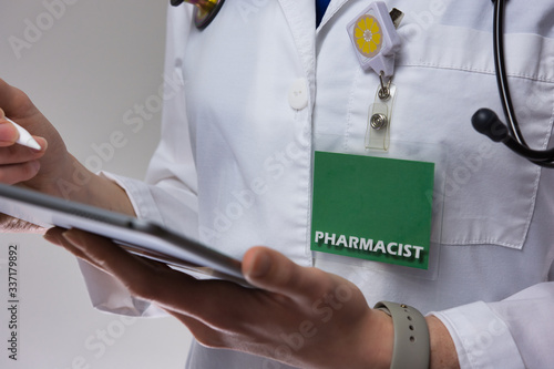 Female pharmacist using electronic medical record for patient care. Up close of medical professional using tablet. Tech in health care. Healthcare technology.