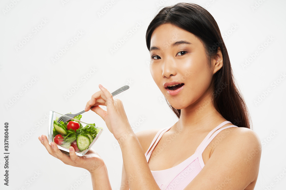 young woman holding a bowl of salad young woman holding a bowl of salad