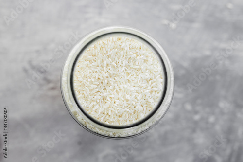 plant-based diet ingredients, kitchen storage jar full of rice shot from top down perspective at shallow depth of field