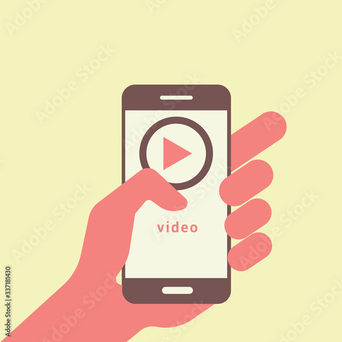 Human hand holding mobile phone and looking at the screen. Blogger using social media