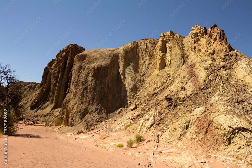 Ancient rock formations eroded by water and wind. Reddish stone formations. Desert landscape