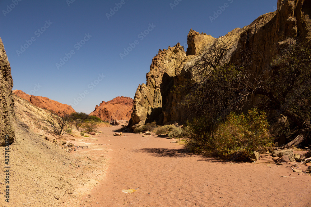 Ancient rock formations eroded by water and wind. Reddish stone formations. Desert landscape Ancient rock formations eroded by water and wind. Reddish stone formations. Desert landscape