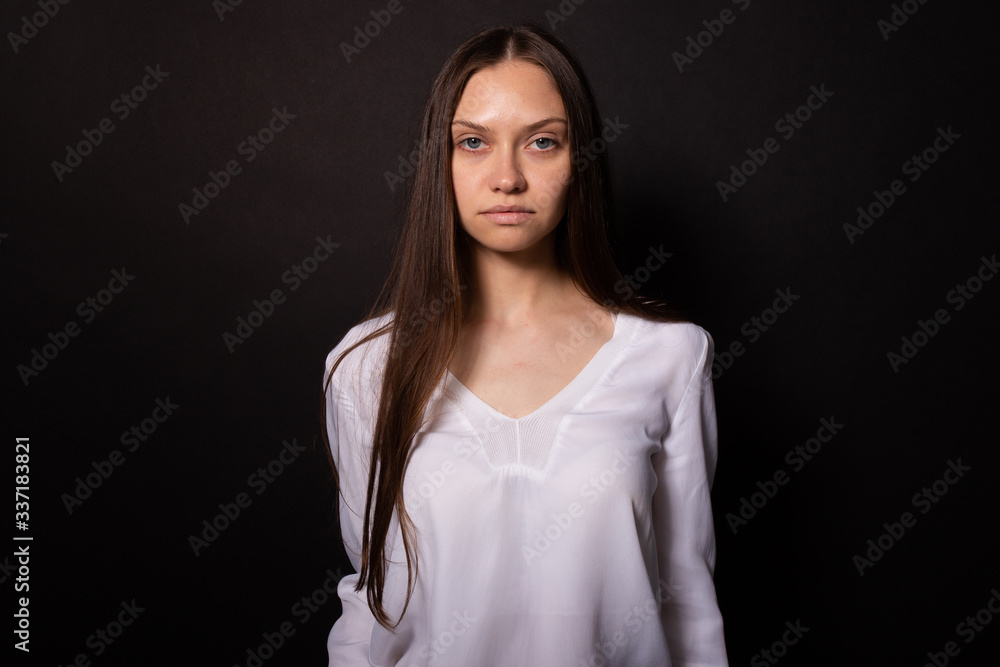 Beautiful caucasian girl with clear no makeup skin looking seriously at ...
