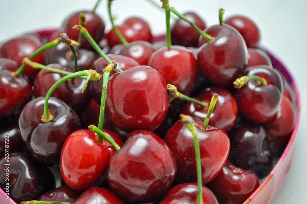 Pile of fresh red cherries with stems Pile of fresh red cherries with stems