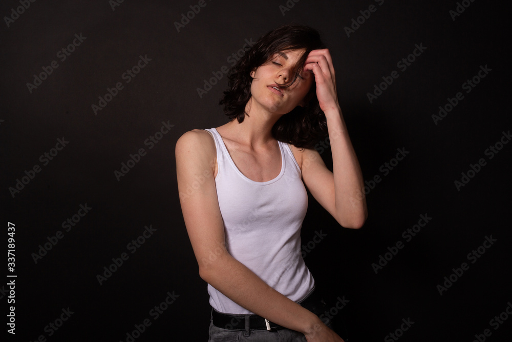 Caucasian girl poses for photoshoot with closed eyes. Isolated, black background Caucasian girl poses for photoshoot with closed eyes. Isolated, black background