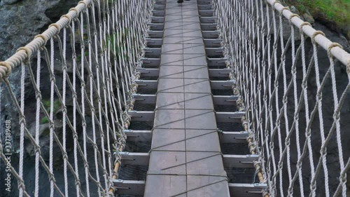 4k cinematic video of a Rope Bridge with a woman walking