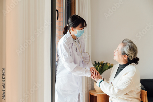 Asian aged woman and doctors photo