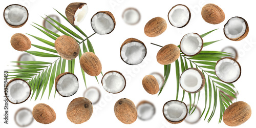 Set with ripe coconuts and palm leaves on white background, top view. Banner design