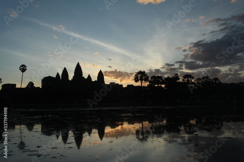 Angkor Wat temple during sunrise, viewed from one of the artificial lakes surrounding the compund.