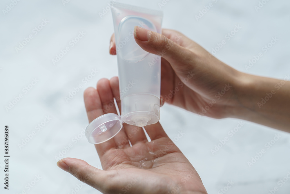 Close up woman using antibacterial hand sanitizer on hands. Close up woman using antibacterial hand sanitizer on hands.