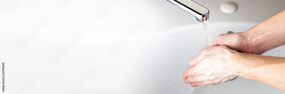 Washing hands with soap under running water in the bathroom over the sink. Hygiene concept for protection against coronavirus infection. Wet soapy hands. Banner background Washing hands with soap under running water in the bathroom over the sink. Hygiene concept for protection against coronavirus infection. Wet soapy hands. Banner background