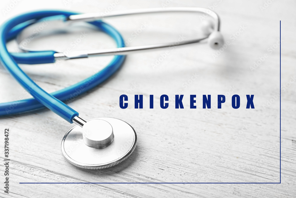 Stethoscope on wooden background, closeup. Chickenpox disease Stethoscope on wooden background, closeup. Chickenpox disease
