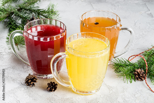 Three different fruit drinks from berries in large glass mugs