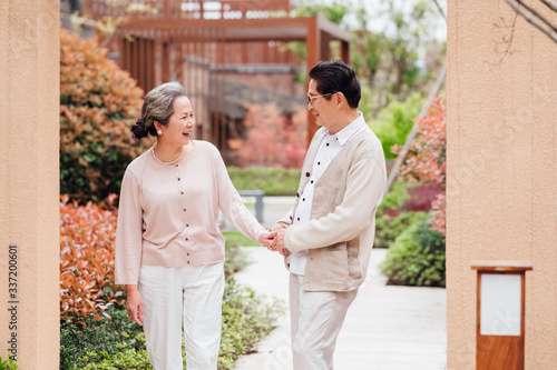 Asian aged couple walking in the area photo