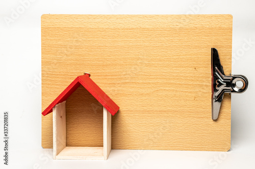 Wall decoration with house shape made from wood isolated on white background. Stay at home concept photo during Covid-19 pandemic. Blank space for customize message. 