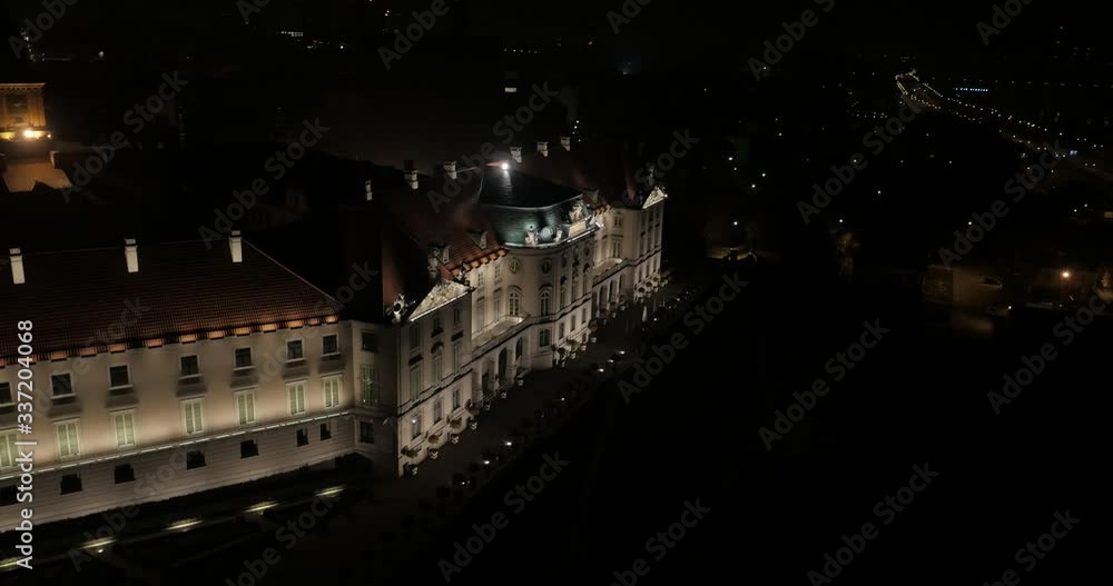 Aerial video showing the royal castle in Warsaw at night and castle gardens. Beautiful baroque architecture on the illuminated facade. Aerial video showing the royal castle in Warsaw at night and castle gardens. Beautiful baroque architecture on the illuminated facade.