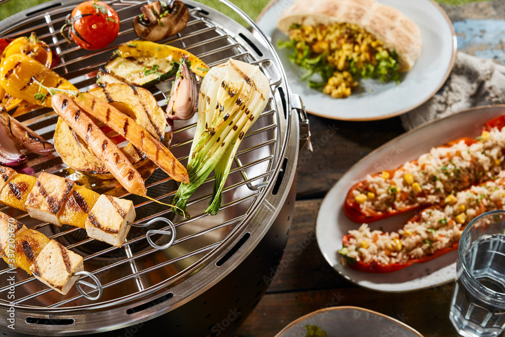 Close up of vegetables on grill and gourmet dishes